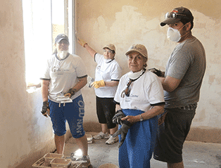 group plastering walls